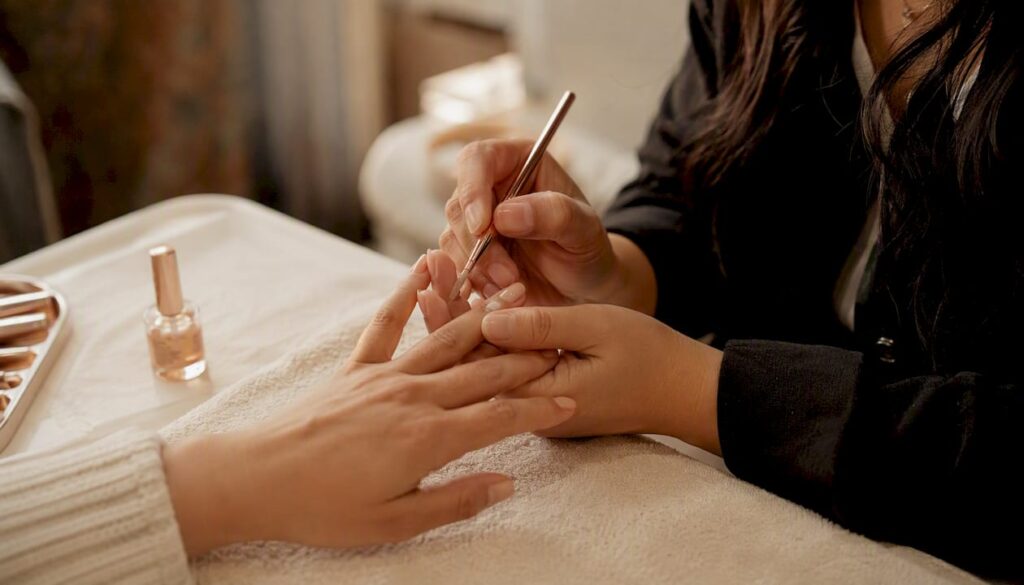 Technician applying acrylic nails close-up