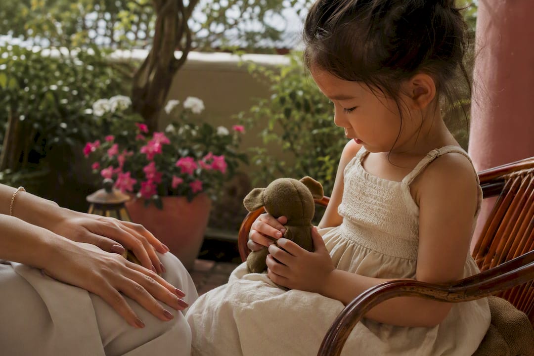 Child playing with toy during nail polish drying
