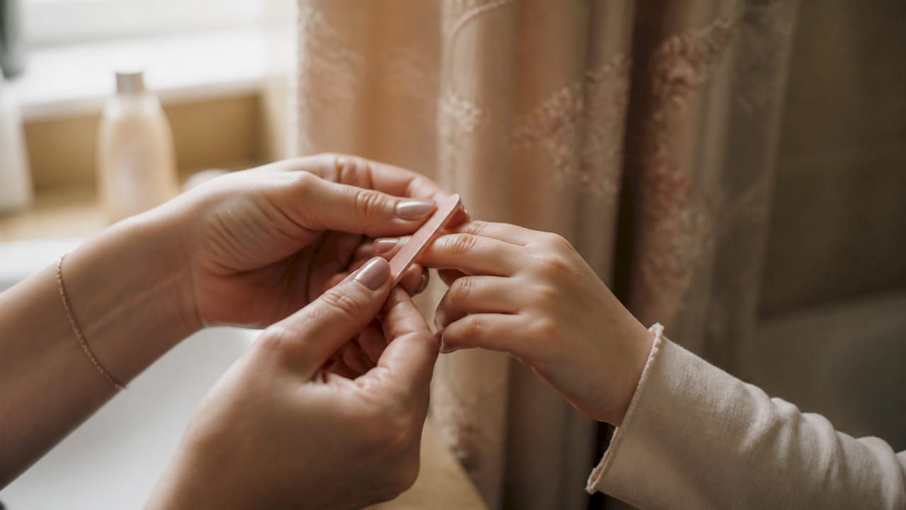 Child's nails gently filed at home after manicure