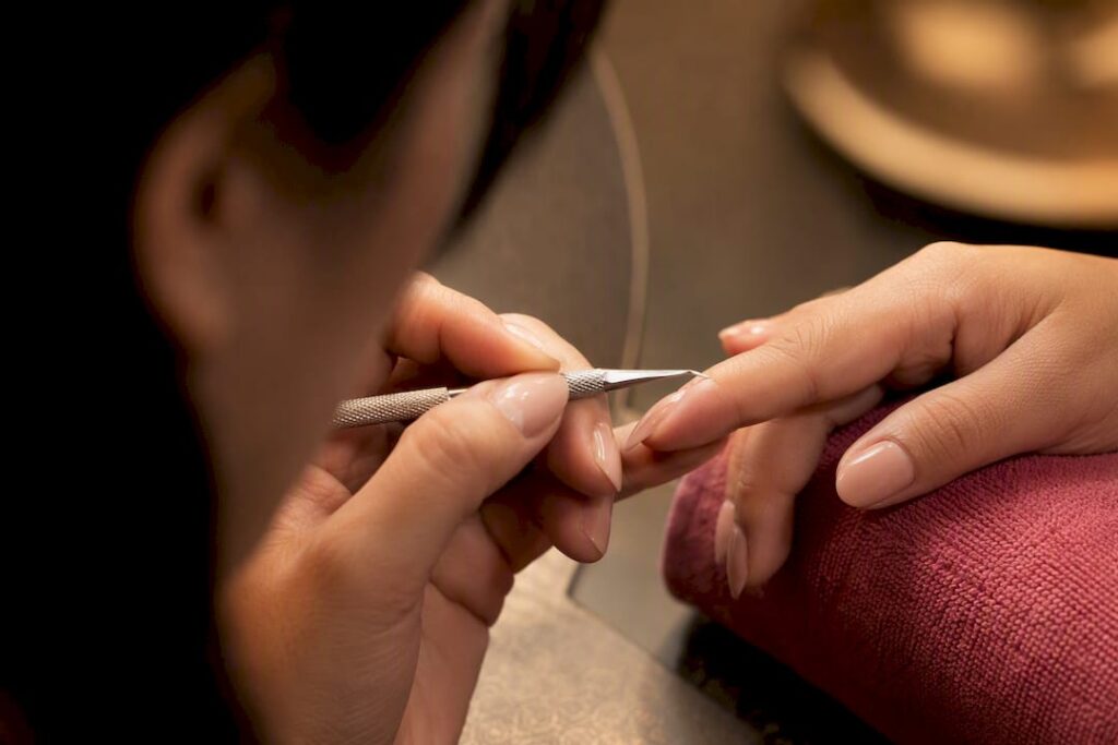 Technician inspecting gel lift near cuticle