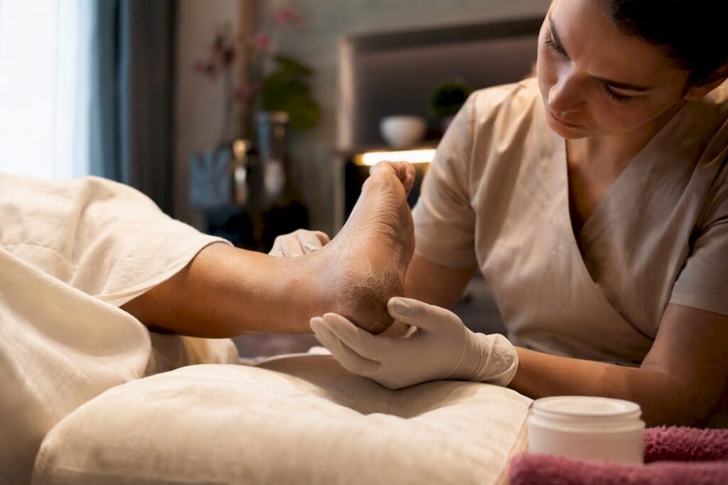 Technician examining a cracked heel during pedicure