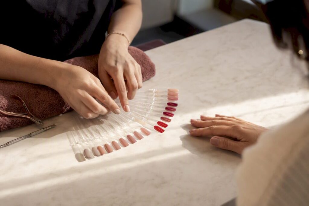 Technician comparing manicure finish samples