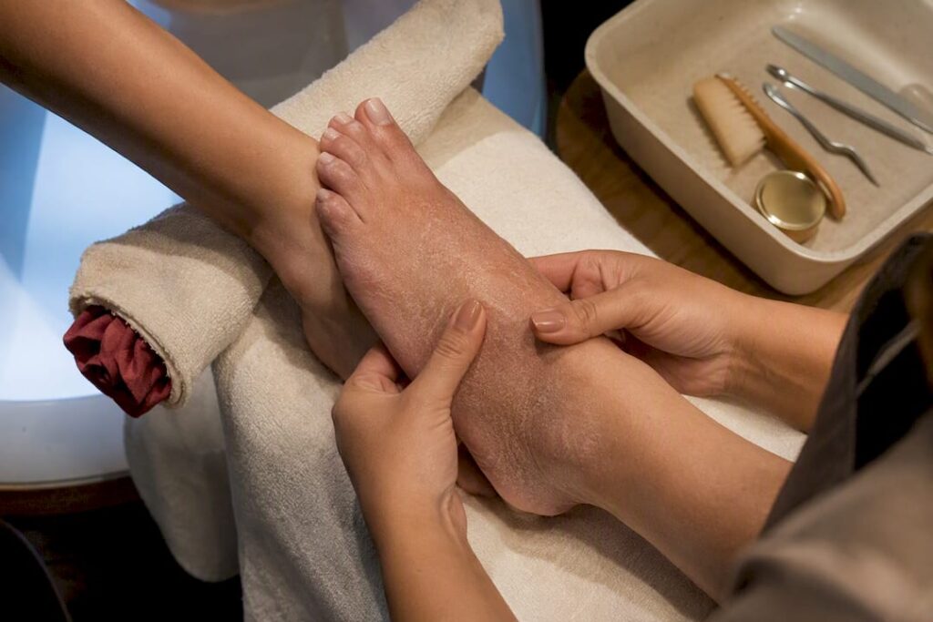 Technician inspecting sensitive skin before pedicure