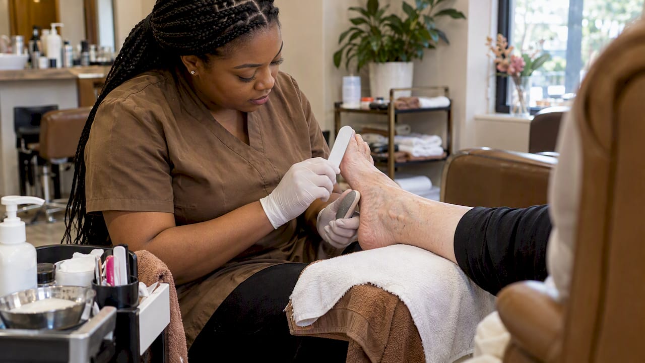 Technician using gentle waterless pedicure tools