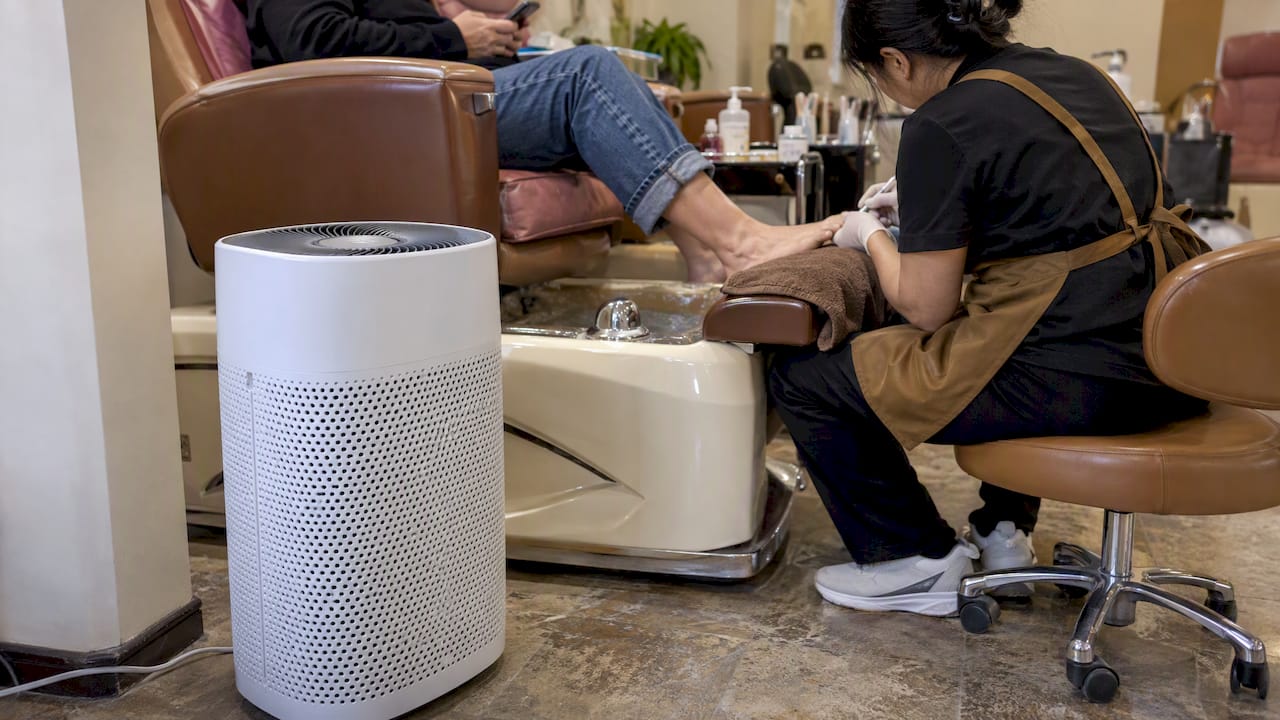 Portable air purifier beside a pedicure workstation